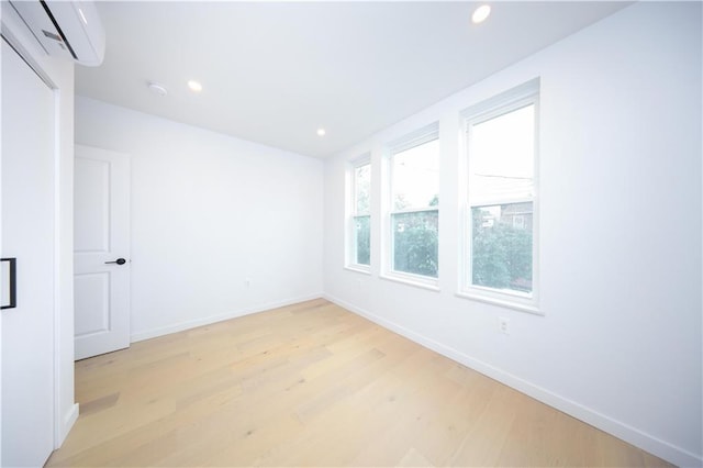 1238 77th St, Brooklyn, NY 11228 - empty room featuring an AC wall unit, light wood-style floors, and recessed lighting