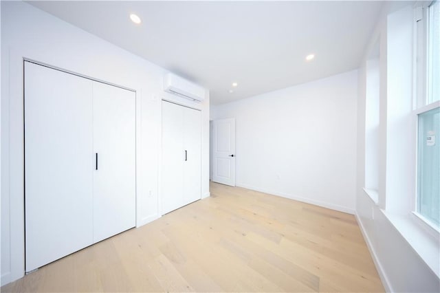 1238 77th St, Brooklyn, NY 11228 - unfurnished bedroom with an AC wall unit, light wood-type flooring, and recessed lighting