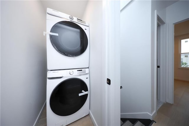 1238 77th St, Brooklyn, NY 11228 - laundry area with stacked washer and clothes dryer and baseboards