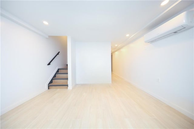 1238 77th St, Brooklyn, NY 11228 - finished basement with a wall mounted air conditioner, recessed lighting, stairway, and wood finished floors
