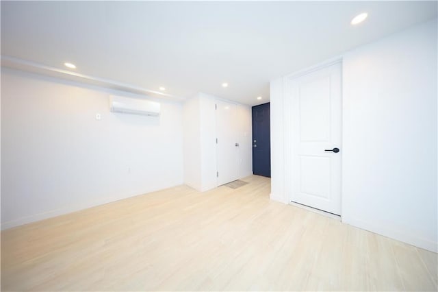 1238 77th St, Brooklyn, NY 11228 - unfurnished room with a wall mounted AC, light wood-style flooring, and recessed lighting