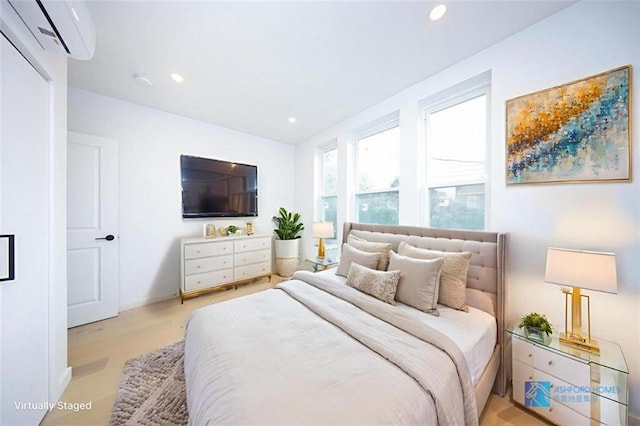 1238 77th St, Brooklyn, NY 11228 - bedroom with a wall unit AC, light wood-style floors, and recessed lighting