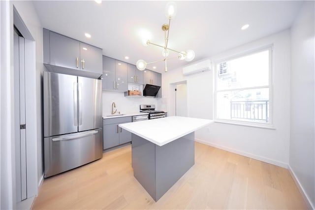 1238 77th St, Brooklyn, NY 11228 - kitchen with stainless steel appliances, a wall unit AC, gray cabinetry, light wood-style flooring, and light countertops