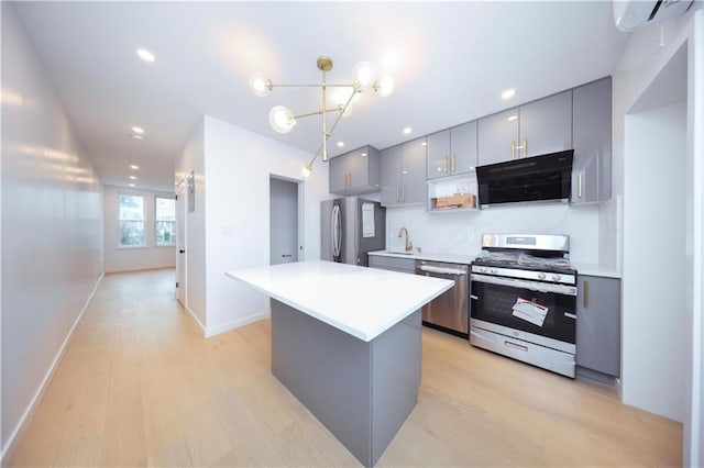 1238 77th St, Brooklyn, NY 11228 - kitchen featuring stainless steel appliances, gray cabinetry, light wood-type flooring, a wall unit AC, and recessed lighting