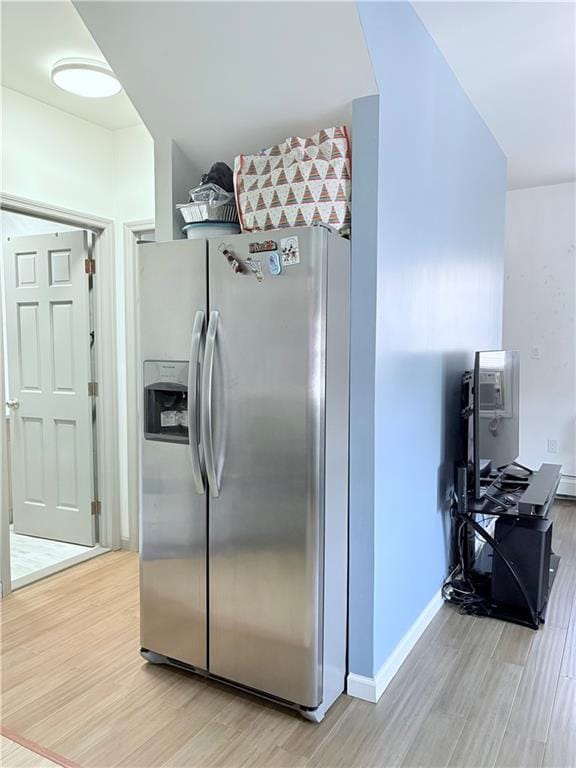 2349 W 12th St, Brooklyn, NY 11223 - kitchen featuring stainless steel refrigerator with ice dispenser, light wood-style floors, and baseboards
