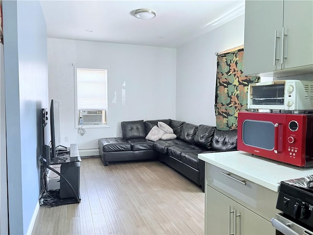 2349 W 12th St, Brooklyn, NY 11223 - living area featuring light wood finished floors, a baseboard heating unit, cooling unit, and baseboards