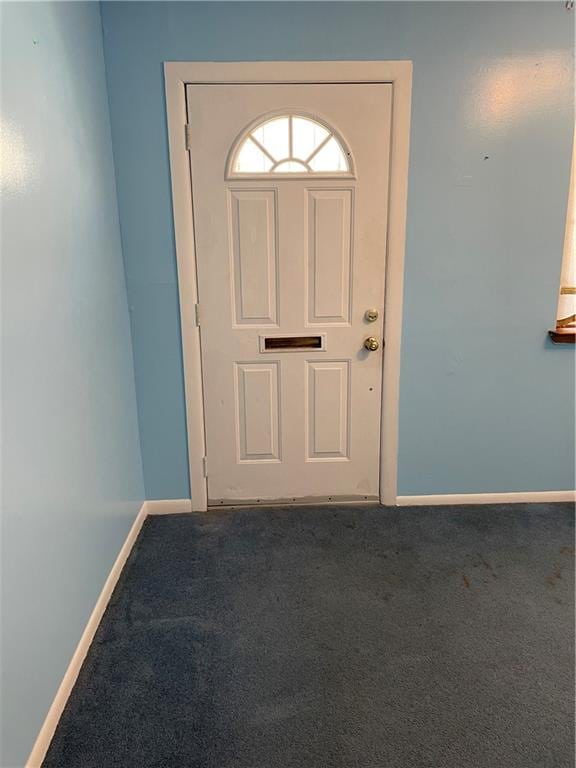 carpeted foyer entrance with baseboards