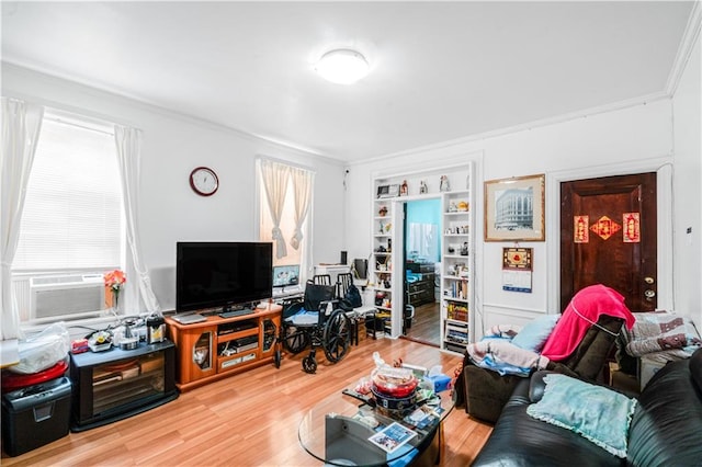 living room with wood finished floors, ornamental molding, cooling unit, and plenty of natural light