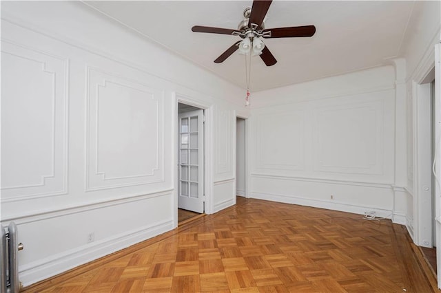unfurnished bedroom with a decorative wall and ceiling fan
