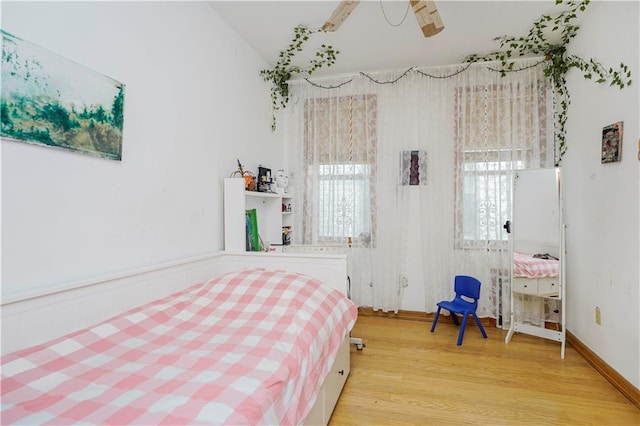 bedroom with wood finished floors and vaulted ceiling