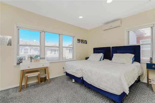 carpeted bedroom with a wall mounted AC, multiple windows, baseboards, and recessed lighting
