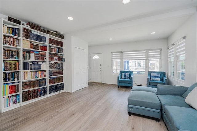 living area with wood finished floors, recessed lighting, and baseboards