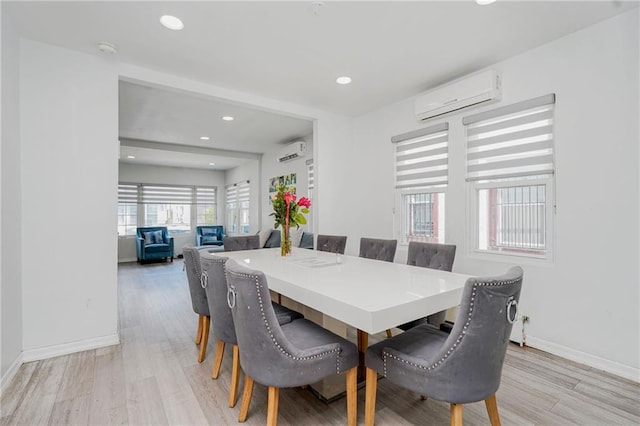 dining space with a wall mounted air conditioner, light wood finished floors, recessed lighting, and baseboards
