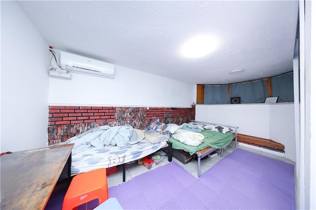 recreation room featuring an AC wall unit and a textured ceiling