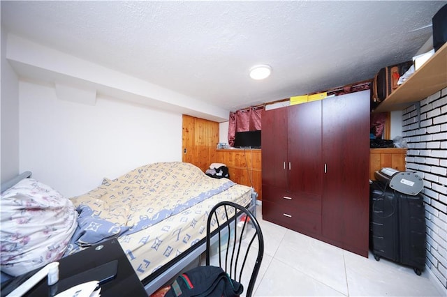 bedroom with light tile patterned floors and a textured ceiling