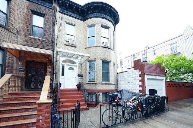view of front facade featuring a garage and brick siding