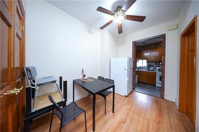 1214 74th St, Brooklyn, NY 11228 - home office with a ceiling fan and light wood-style flooring