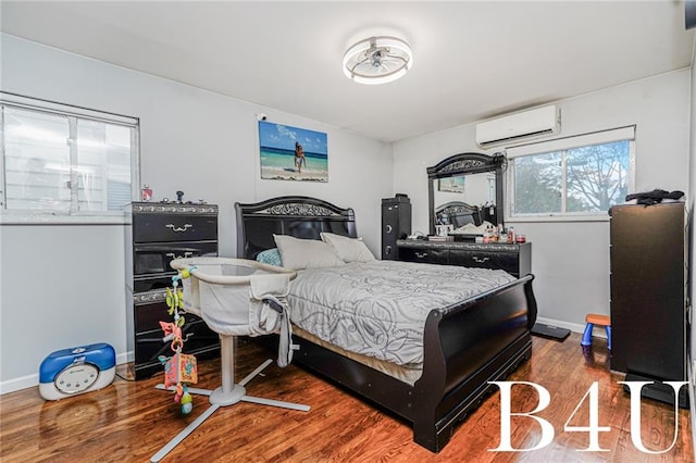 2538 Mill Ave, Brooklyn, NY 11234 - bedroom with a wall mounted AC, wood finished floors, and baseboards