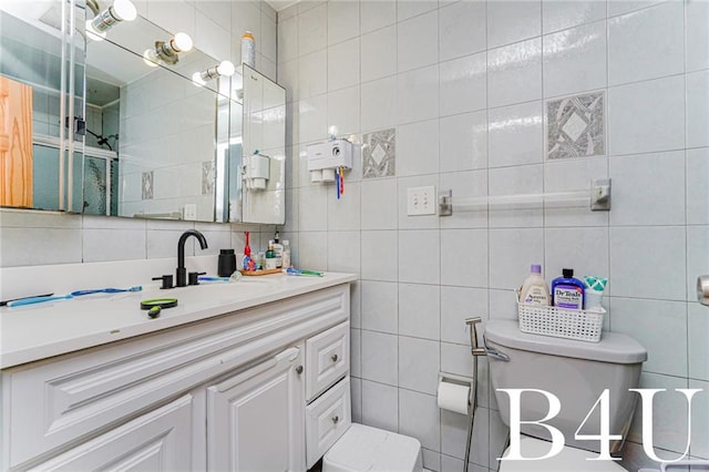 2538 Mill Ave, Brooklyn, NY 11234 - bathroom featuring tile walls, toilet, vanity, and backsplash
