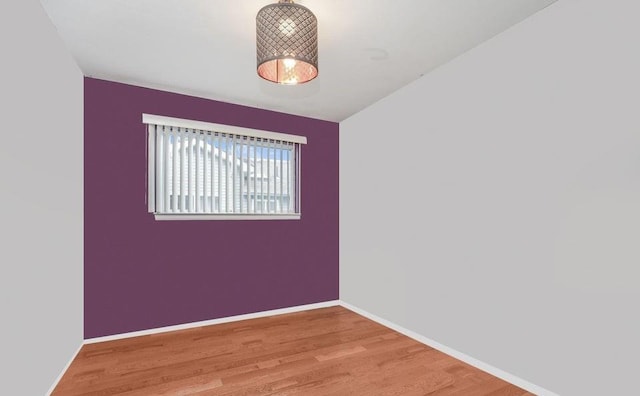 unfurnished room with light wood finished floors and baseboards