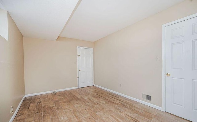 empty room with light wood-type flooring and baseboards