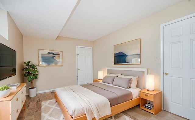 bedroom featuring light wood-style floors and baseboards