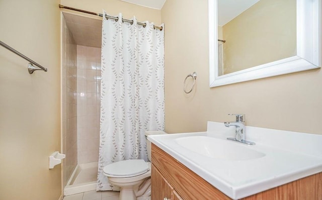 full bathroom with a stall shower, toilet, vanity, and tile patterned floors