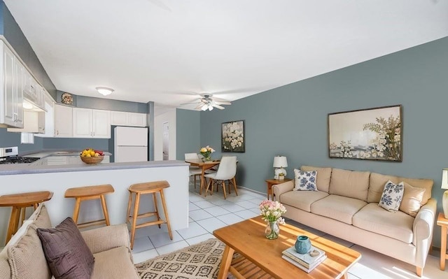 living room with light tile patterned flooring and a ceiling fan