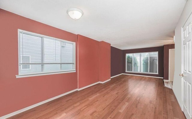 unfurnished room featuring wood finished floors and baseboards