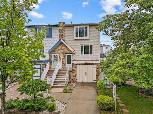 multi unit property featuring stone siding and stairs