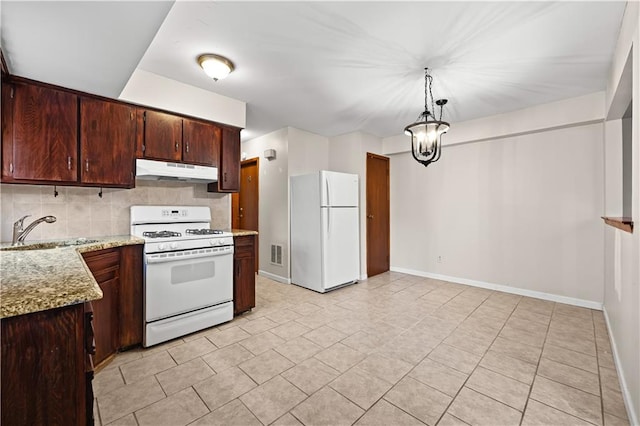 kitchen featuring white appliances, under cabinet range hood, a sink, decorative backsplash, and baseboards
