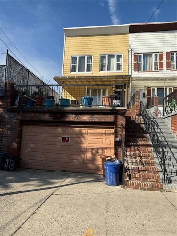 1113 68th St, Brooklyn, NY 11219 - view of front of home with stairs, a garage, and concrete driveway