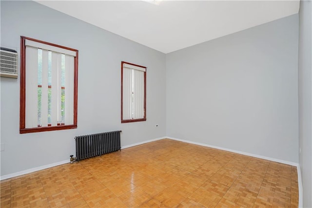 1113 68th St, Brooklyn, NY 11219 - empty room with radiator, baseboards, and a wall mounted air conditioner