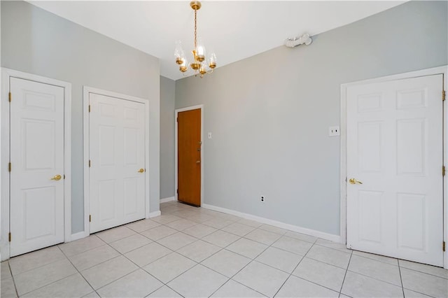 1113 68th St, Brooklyn, NY 11219 - spare room with a chandelier, light tile patterned floors, and baseboards
