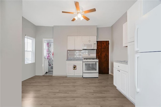 1113 68th St, Brooklyn, NY 11219 - kitchen with white appliances, ceiling fan, white cabinetry, and light wood finished floors