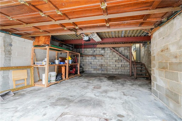 1113 68th St, Brooklyn, NY 11219 - basement featuring concrete block wall, stairs, and a garage