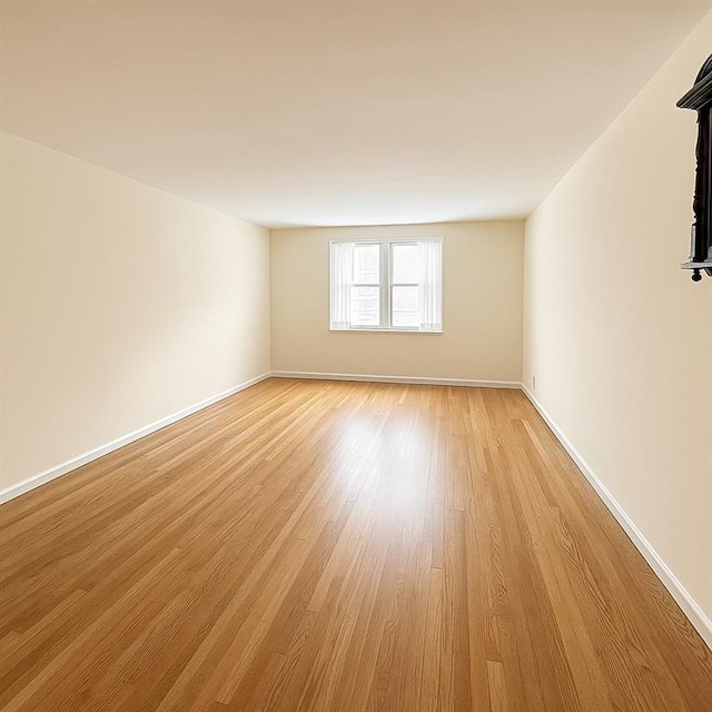 unfurnished room featuring light wood-style flooring and baseboards