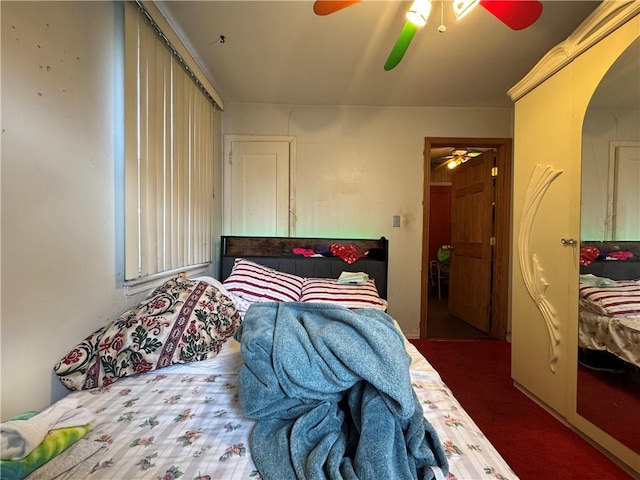 carpeted bedroom featuring arched walkways and a ceiling fan