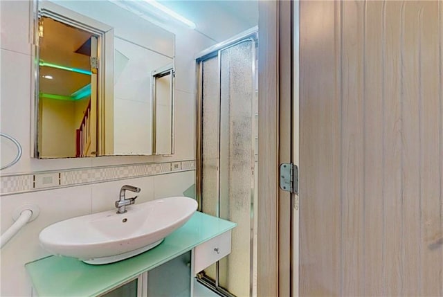 2291 E 21st St, Brooklyn, NY 11229 - bathroom with tile walls, vanity, a shower stall, and decorative backsplash