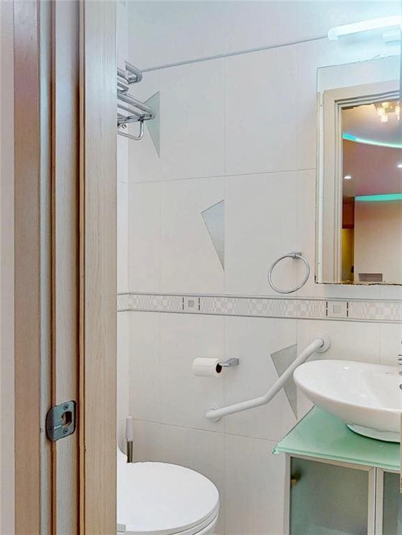 2291 E 21st St, Brooklyn, NY 11229 - bathroom with tile walls, vanity, and toilet