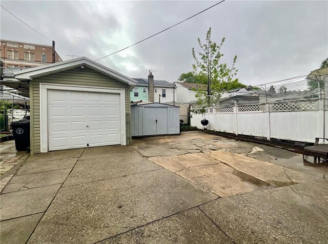 2291 E 21st St, Brooklyn, NY 11229 - detached garage featuring driveway and a storage shed