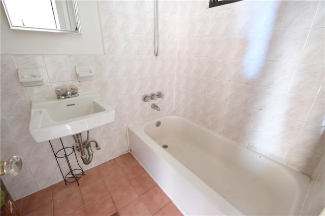 642 56th St, Brooklyn, NY 11220 - bathroom with tile patterned flooring, tile walls, and shower / bathtub combination