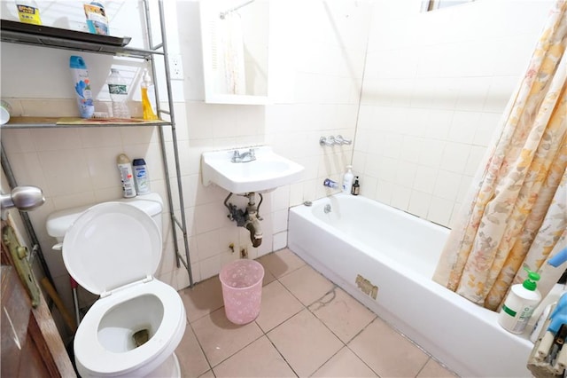 642 56th St, Brooklyn, NY 11220 - bathroom featuring tile walls, tile patterned floors, a sink, shower / tub combo, and toilet