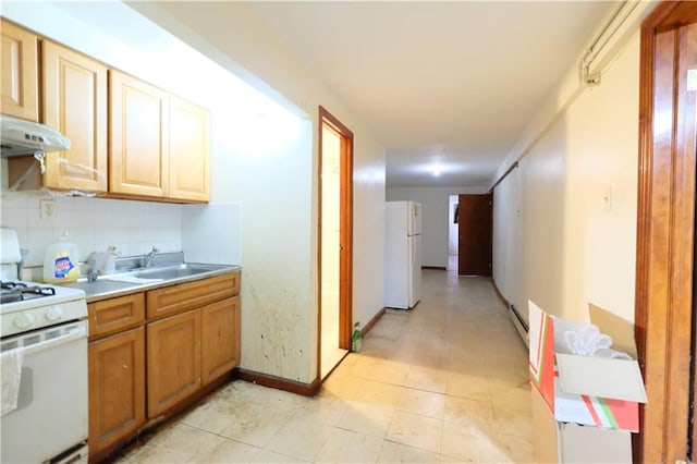 642 56th St, Brooklyn, NY 11220 - kitchen featuring white appliances, a sink, a baseboard heating unit, light countertops, and decorative backsplash