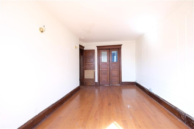 642 56th St, Brooklyn, NY 11220 - spare room with wood finished floors and baseboards