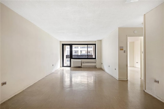 333 Pearl St Unit 8E, New York, NY 10038 - unfurnished room featuring radiator heating unit and a textured ceiling
