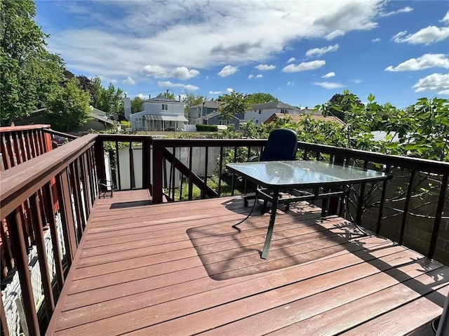 wooden terrace featuring a residential view and outdoor dining space