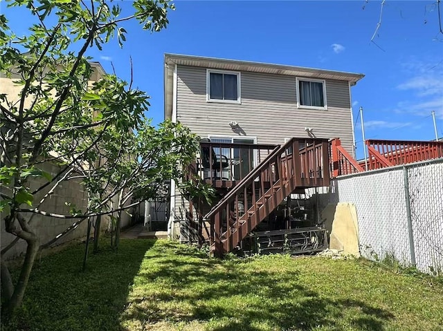 back of house featuring stairway and a wooden deck
