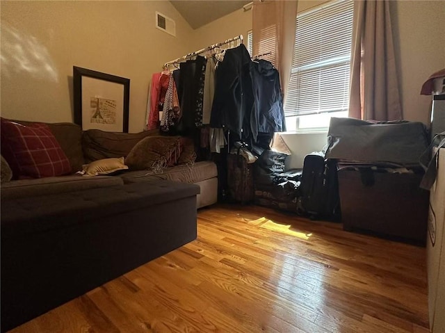 living room with wood finished floors and lofted ceiling