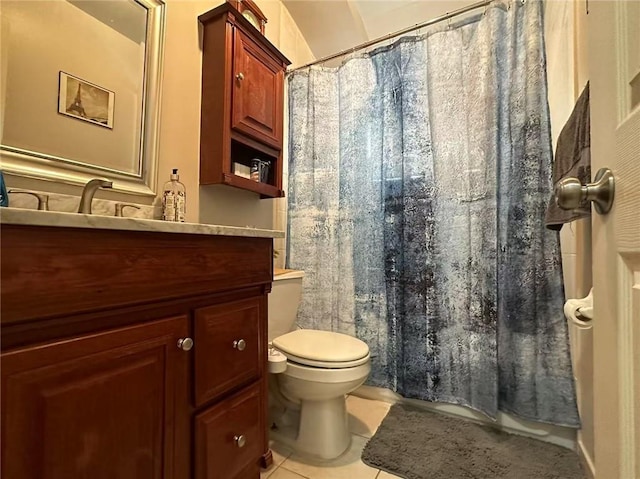 bathroom with tile patterned floors, toilet, vanity, and a shower with shower curtain